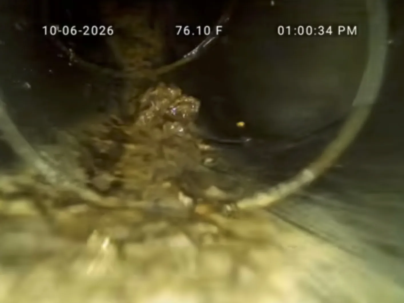 Sewer camera view of grease collecting again farther down a main sewer lateral