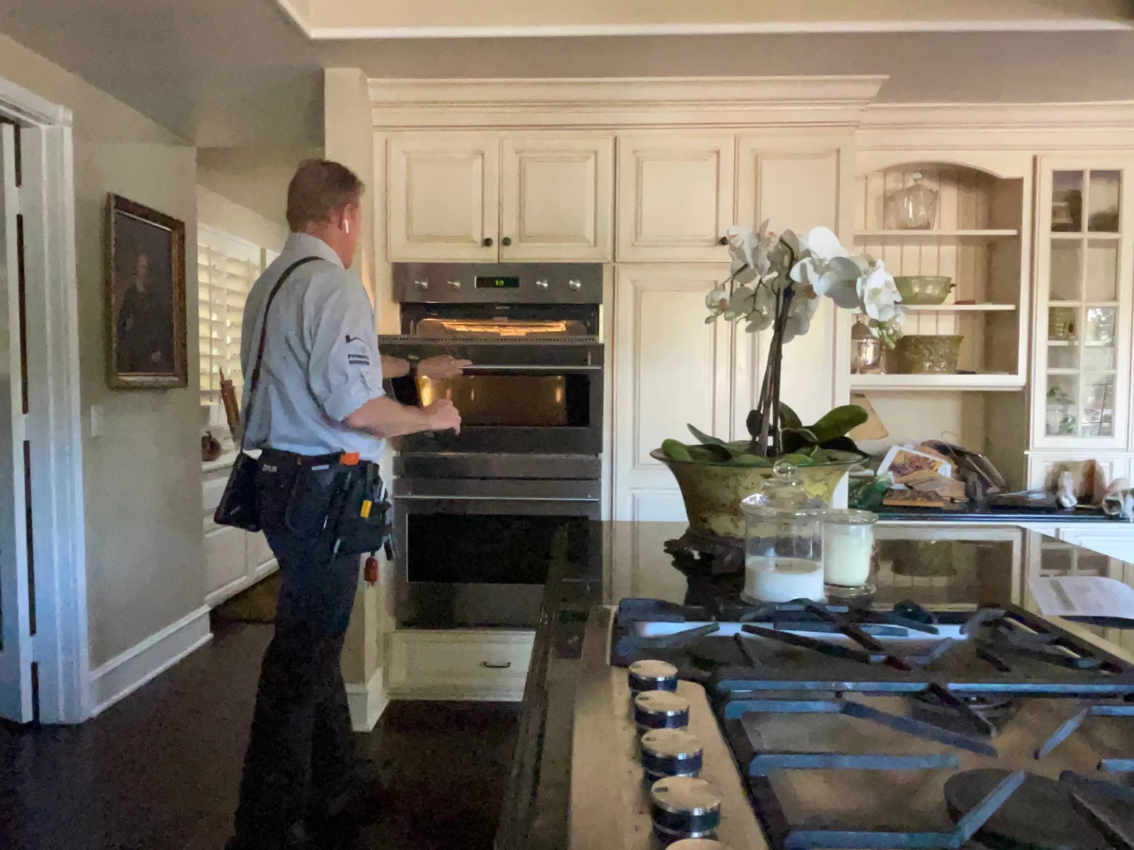 Rob Kruger testing built-in kitchen appliances during a home inspection