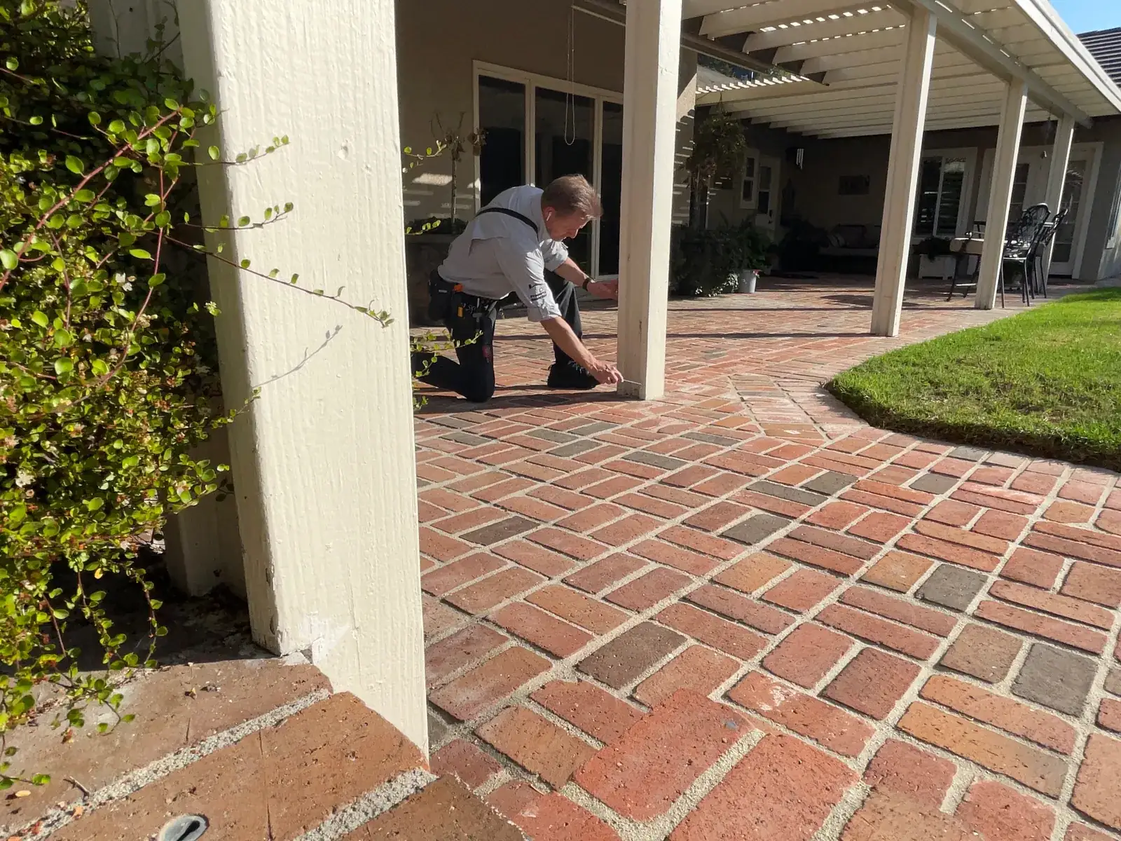 Rob Kruger examining exterior stucco and structure at a home inspection