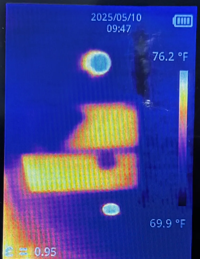 Thermal camera display showing two bright yellow rectangles against a cool blue ceiling, with a temperature scale reading 69.9 to 76.2 degrees Fahrenheit